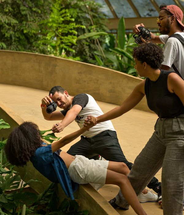 A diverse group of people smiling during a light yoga session.